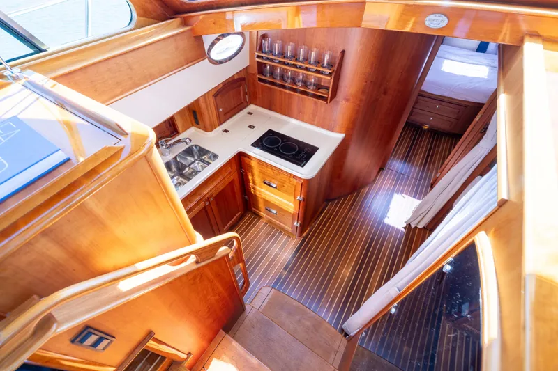 Barefoot Yacht Photos Pics Luxurious interior of 2014 Hinckley Talaria 48 Flybridge yacht with wood finish and modern kitchen.
