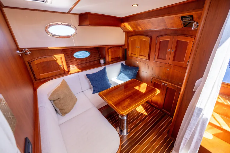 Barefoot Yacht Photos Pics Luxurious 2014 Hinckley Talaria 48 Flybridge interior with elegant wood finish and cozy seating.