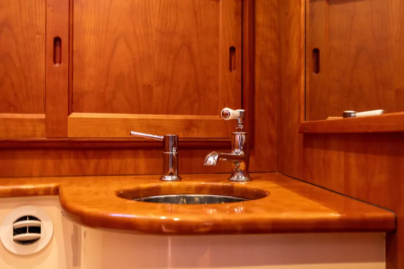 Barefoot Yacht Photos Pics Wooden bathroom vanity with sink on 2014 Hinckley Talaria 48 Flybridge yacht.