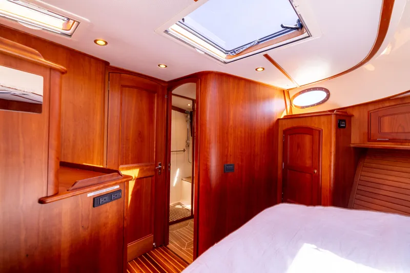 Barefoot Yacht Photos Pics Luxurious 2014 Hinckley Talaria 48 Flybridge interior with elegant wood finish and skylight.