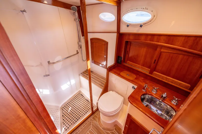 Barefoot Yacht Photos Pics Luxurious 2014 Hinckley Talaria 48 Flybridge yacht bathroom with wood accents and modern fixtures.