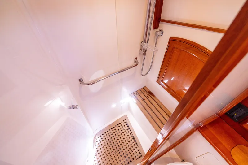 Barefoot Yacht Photos Pics 2014 Hinckley Talaria 48 Flybridge shower with wooden bench and chrome fixtures.