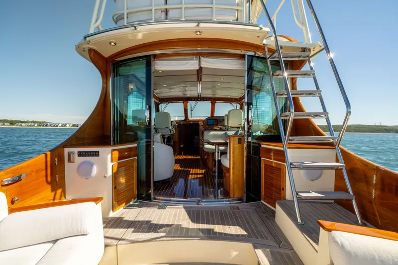 Barefoot Yacht Photos Pics 2014 Hinckley Talaria 48 Flybridge yacht interior with elegant wood finish and open flybridge access.