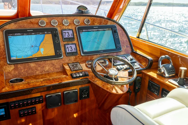 Barefoot Yacht Photos Pics Helm of 2014 Hinckley Talaria 48 Flybridge with navigation screens and controls.