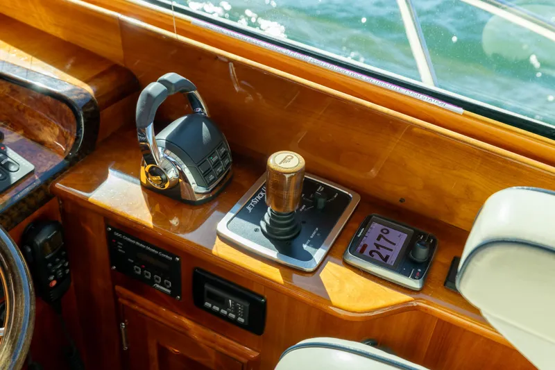 Barefoot Yacht Photos Pics Helm controls of 2014 Hinckley Talaria 48 Flybridge with joystick and navigation display.