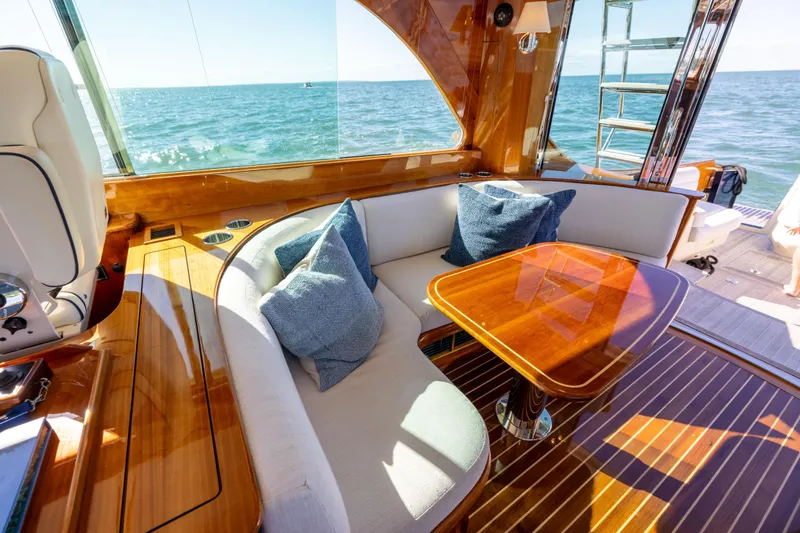Barefoot Yacht Photos Pics Luxurious interior of 2014 Hinckley Talaria 48 Flybridge yacht with elegant wood finish.