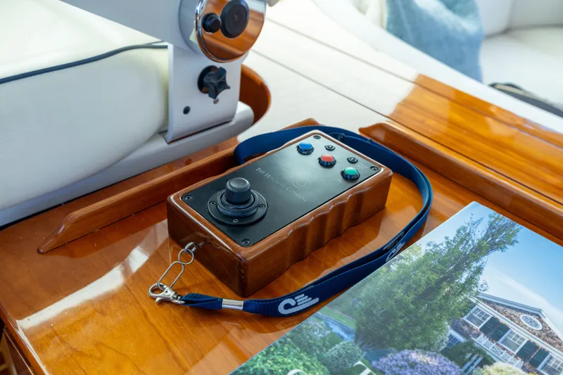 Barefoot Yacht Photos Pics Control panel on 2014 Hinckley Talaria 48 Flybridge yacht, featuring joystick and buttons.