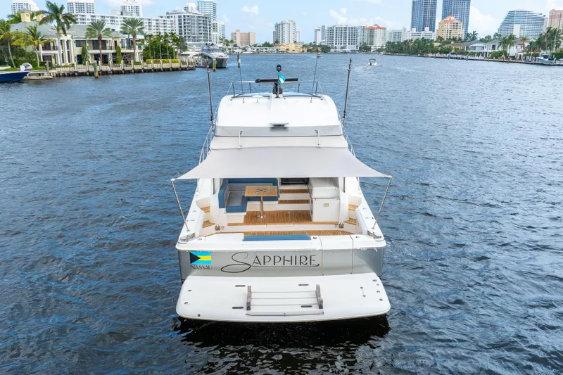 Sapphire Yacht Photos Pics 2022 Riviera 575 SUV yacht "Sapphire" cruising on a scenic waterway.