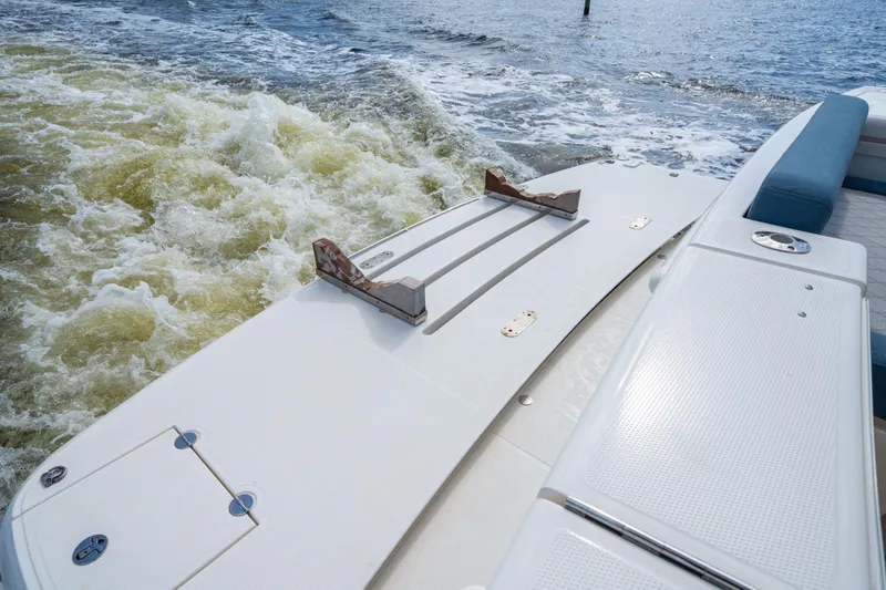 Sapphire Yacht Photos Pics 2022 Riviera 575 SUV boat with swim platform on water.