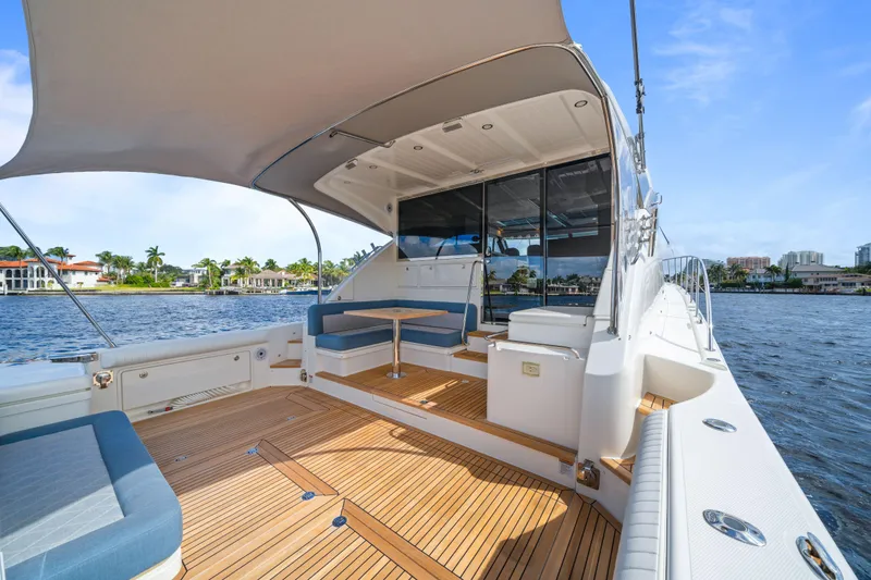 Sapphire Yacht Photos Pics Luxurious 2022 Riviera 575 SUV yacht with spacious deck and waterfront view.