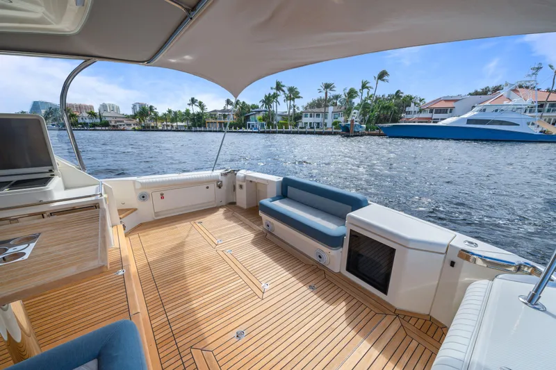Sapphire Yacht Photos Pics Spacious deck of 2022 Riviera 575 SUV yacht with waterfront view.