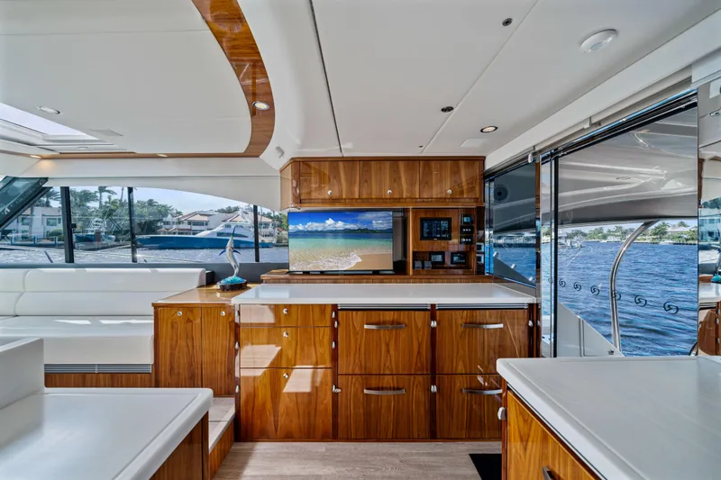 Sapphire Yacht Photos Pics Luxurious interior of 2022 Riviera 575 SUV yacht with elegant wood finishes and scenic views.