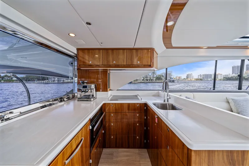 Sapphire Yacht Photos Pics Luxurious kitchen interior of 2022 Riviera 575 SUV yacht with waterfront view.