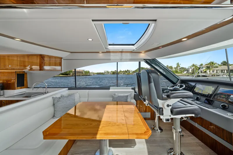 Sapphire Yacht Photos Pics Luxurious interior of 2022 Riviera 575 SUV yacht with modern helm and dining area.