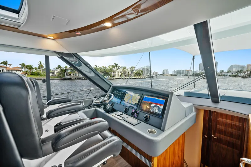 Sapphire Yacht Photos Pics Luxurious 2022 Riviera 575 SUV yacht interior with modern navigation system and waterfront view.
