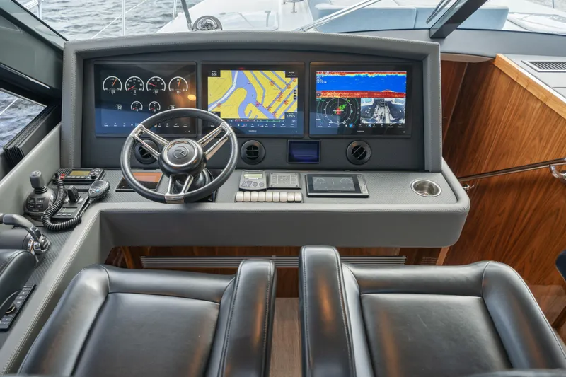 Sapphire Yacht Photos Pics 2022 Riviera 575 SUV helm with advanced navigation displays and luxurious leather seating.