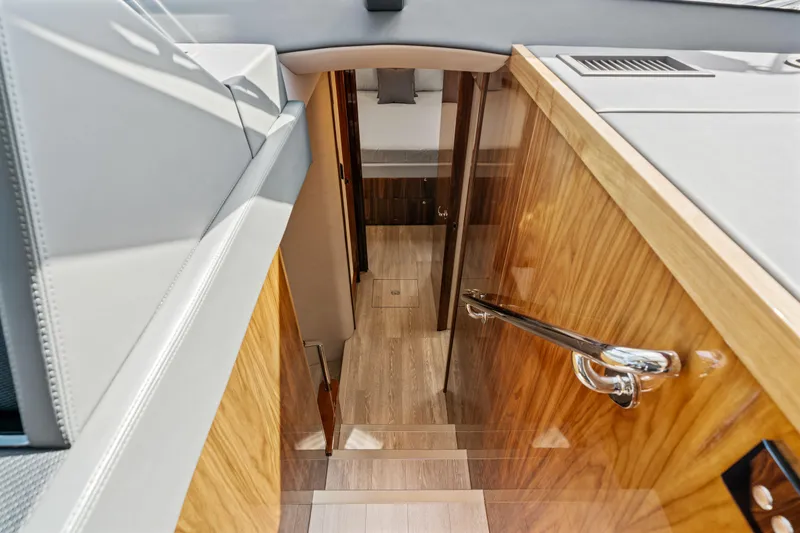 Sapphire Yacht Photos Pics Interior staircase of 2022 Riviera 575 SUV yacht with wooden finish and modern design.