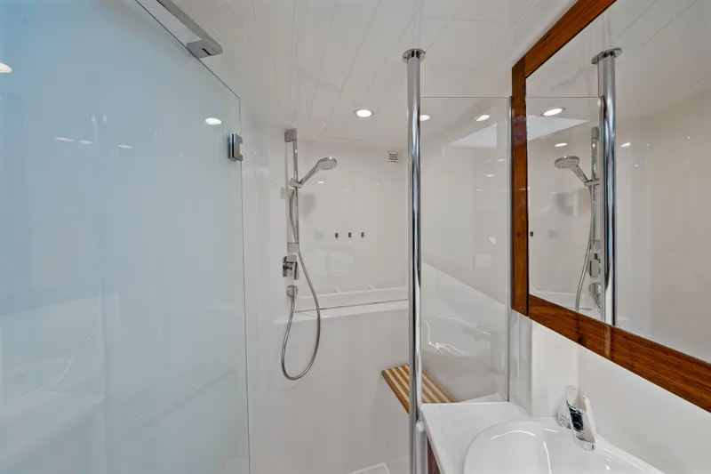 Sapphire Yacht Photos Pics Luxurious bathroom in 2022 Riviera 575 SUV yacht with modern shower and sleek design.