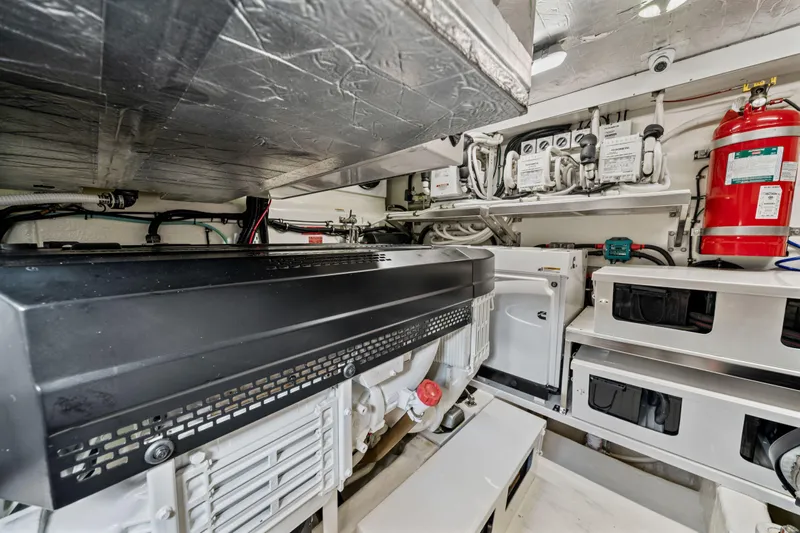 Sapphire Yacht Photos Pics Engine room of 2022 Riviera 575 SUV yacht with equipment and fire extinguisher.