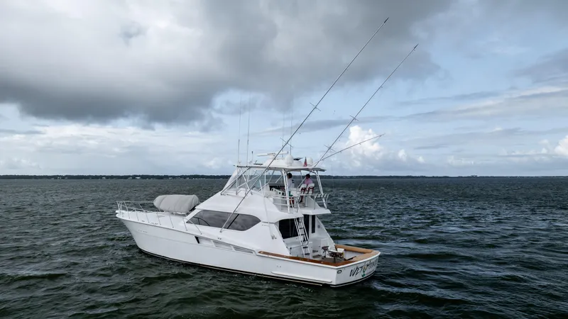 Wet Hooker Yacht Photos Pics 2003 Hatteras 60 Convertible yacht on open water under cloudy skies.