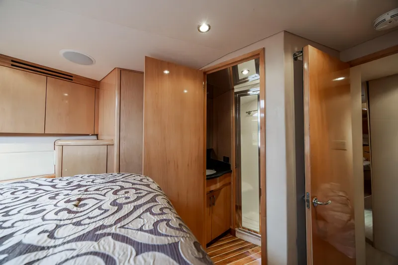 Wet Hooker Yacht Photos Pics Luxurious cabin interior of 2003 Hatteras 60 Convertible yacht with wood finishes.