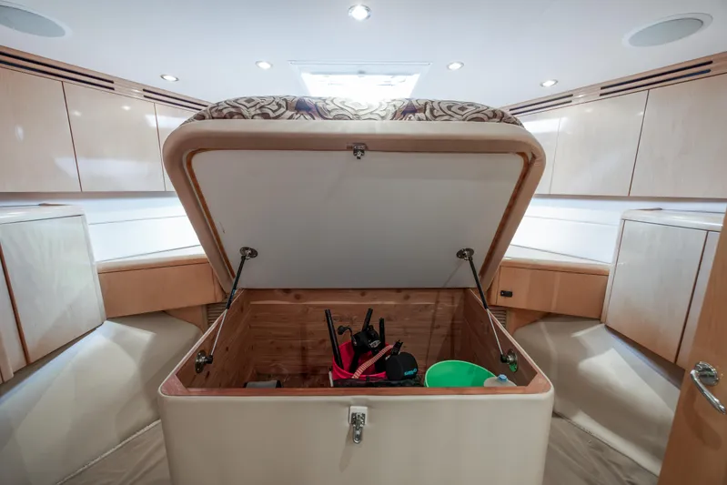 Wet Hooker Yacht Photos Pics Interior storage compartment on 2003 Hatteras 60 Convertible yacht, open with items inside.