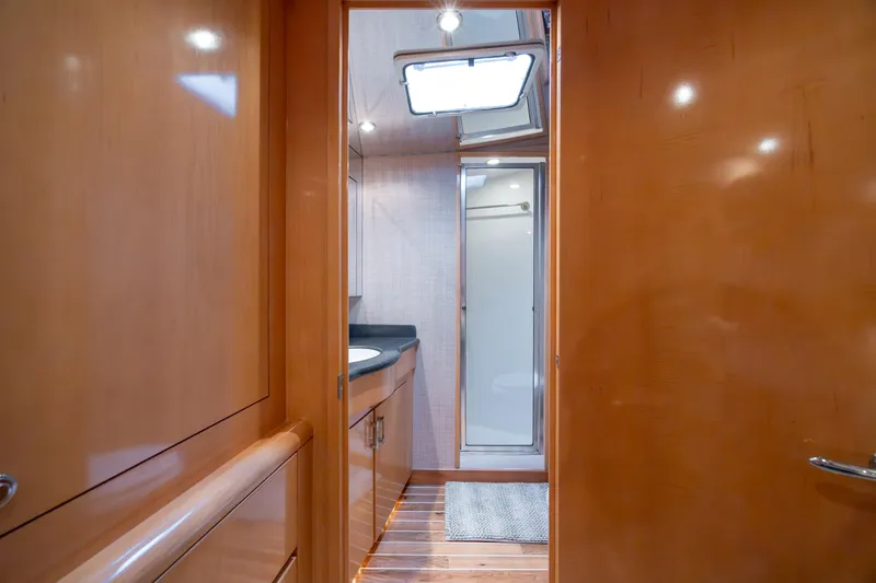 Wet Hooker Yacht Photos Pics Interior of 2003 Hatteras 60 Convertible yacht bathroom with wood finish and shower.
