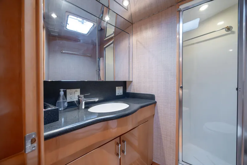 Wet Hooker Yacht Photos Pics Luxurious bathroom in 2003 Hatteras 60 Convertible yacht with modern fixtures.