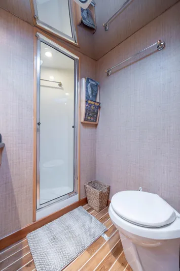 Wet Hooker Yacht Photos Pics Bathroom interior of 2003 Hatteras 60 Convertible yacht, featuring shower and toilet.