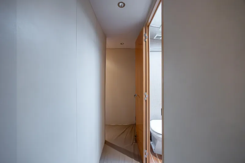 Wet Hooker Yacht Photos Pics Narrow hallway leading to a bathroom on a 2003 Hatteras 60 Convertible yacht.