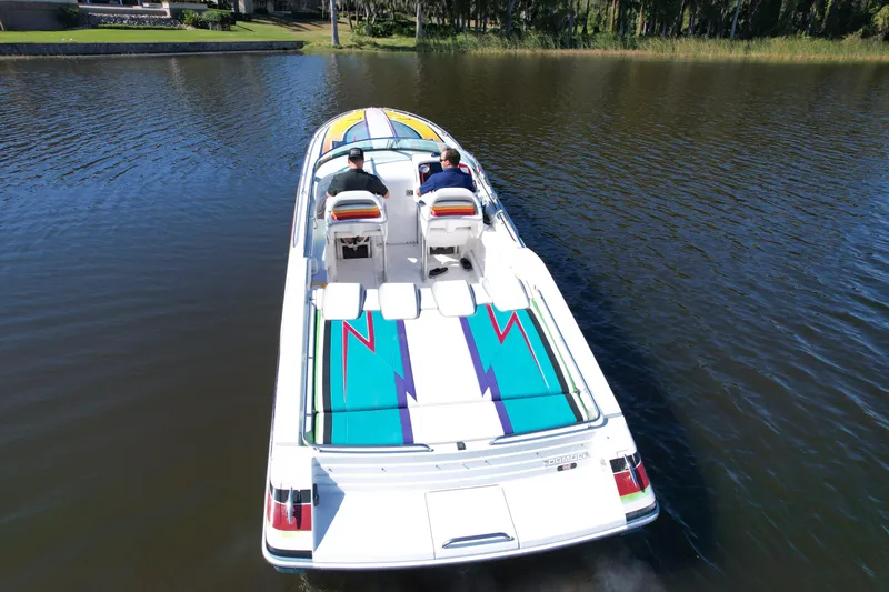  Yacht Photos Pics 2006 Formula 382 FASTech speedboat cruising on a calm lake, vibrant design visible.