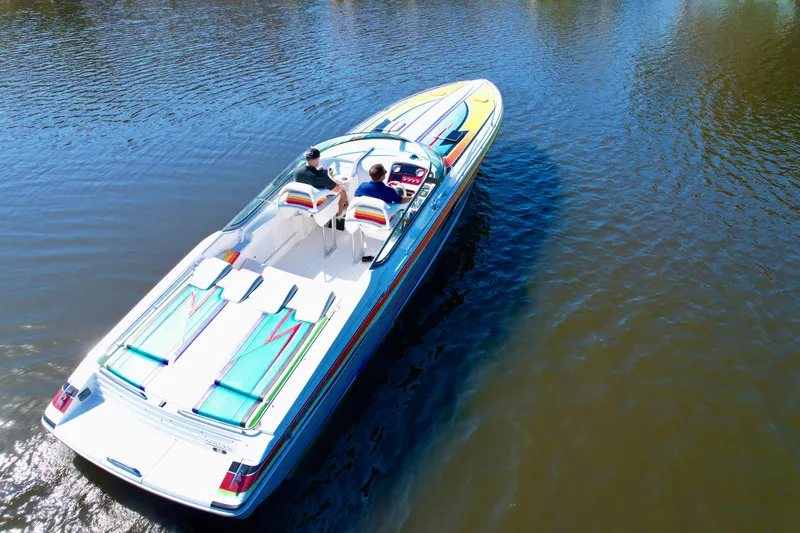  Yacht Photos Pics 2006 Formula 382 FASTech speedboat cruising on calm water, featuring vibrant graphics.