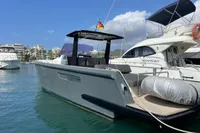 2012 Fjord 36' Open boat docked in a marina, featuring sleek design and German flag.