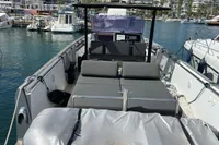 2012 Fjord 36' Open boat docked in a marina with cityscape background.