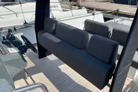 2012 Fjord 36' Open boat interior with gray seating and steering wheel.