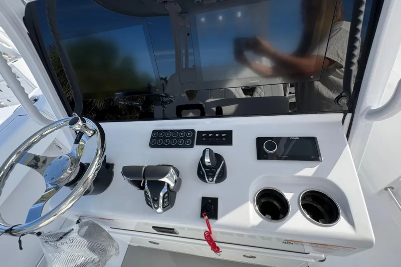  Yacht Photos Pics 2026 Sportsman Open 302 Center Console dashboard with steering wheel, controls, and display screen.