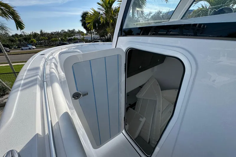  Yacht Photos Pics 2026 Sportsman Open 302 Center Console boat with open storage compartment.