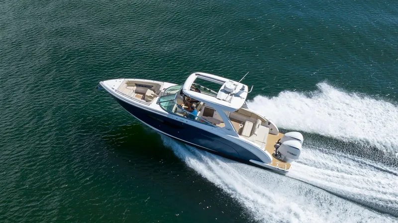 Poly Yacht Photos Pics 2019 Regal 33 OBX boat cruising swiftly on open water.