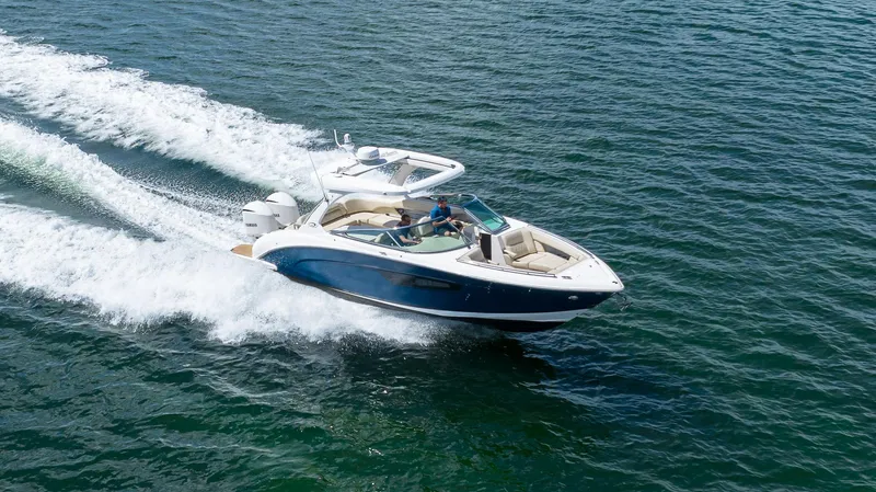 Poly Yacht Photos Pics 2019 Regal 33 OBX boat cruising on open water.