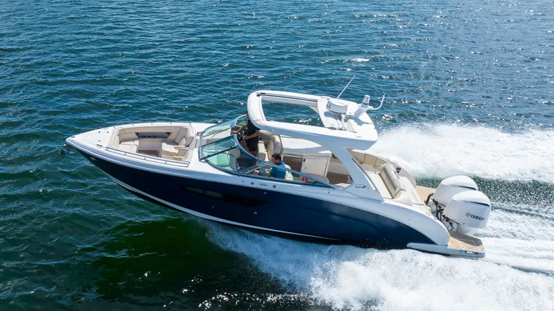 Poly Yacht Photos Pics 2019 Regal 33 OBX boat cruising on open water, showcasing sleek design and powerful engines.
