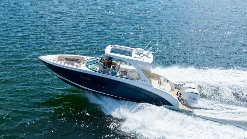 Poly Yacht Photos Pics 2019 Regal 33 OBX boat cruising on open water.