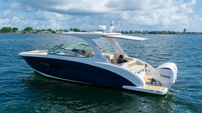 Poly Yacht Photos Pics 2019 Regal 33 OBX boat cruising on a sunny day with Yamaha engines.