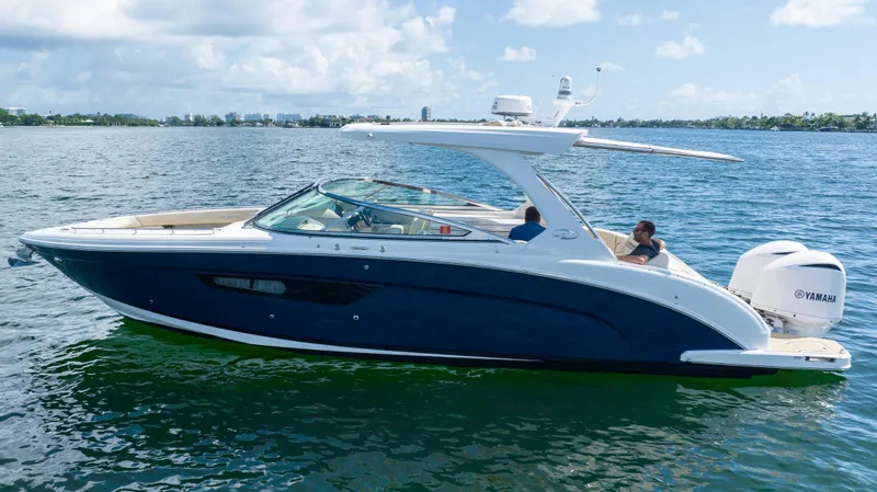 Poly Yacht Photos Pics 2019 Regal 33 OBX boat cruising on a sunny day.
