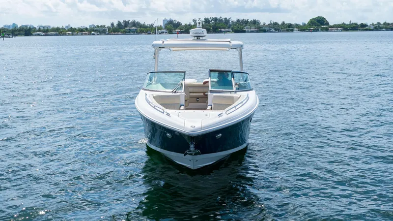 Poly Yacht Photos Pics 2019 Regal 33 OBX boat on calm water, front view.