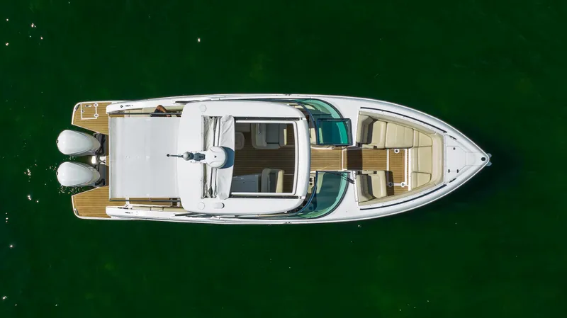Poly Yacht Photos Pics 2019 Regal 33 OBX boat, aerial view, on green water.