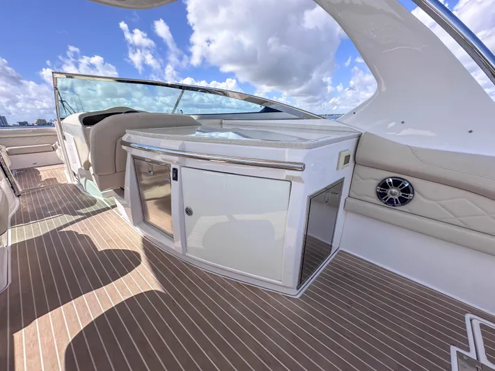 Poly Yacht Photos Pics 2019 Regal 33 OBX boat interior with sleek cabinetry and seating under a blue sky.