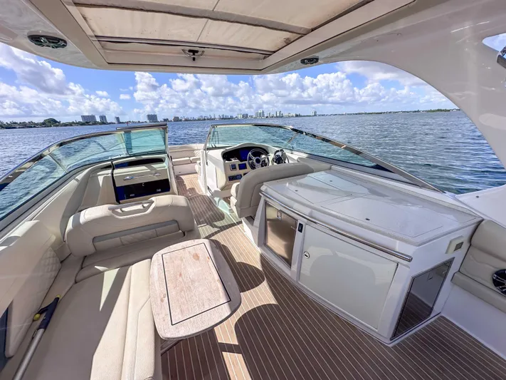 Poly Yacht Photos Pics 2019 Regal 33 OBX boat interior with seating, table, and water view.
