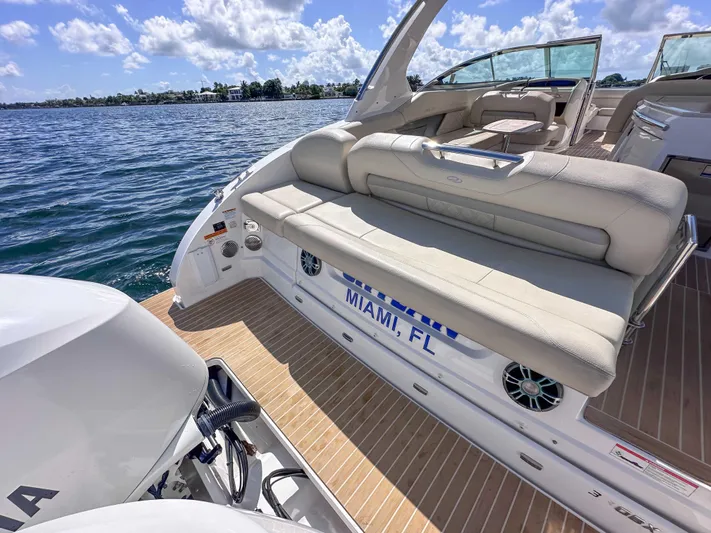 Poly Yacht Photos Pics 2019 Regal 33 OBX boat with beige seating, docked in Miami, FL, under a sunny sky.