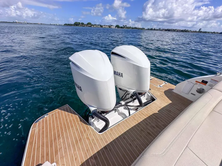 Poly Yacht Photos Pics 2019 Regal 33 OBX boat with twin Yamaha outboard engines on a sunny day.