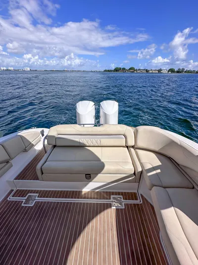 Poly Yacht Photos Pics 2019 Regal 33 OBX boat with spacious deck and seating, overlooking calm blue waters.